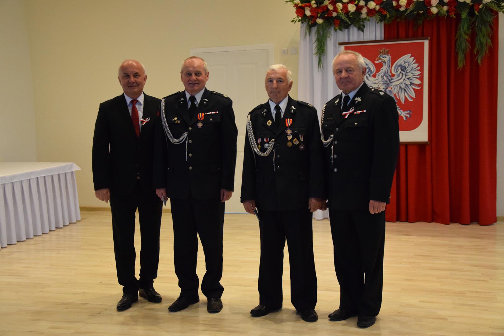 Zdjęcie przedstawia moment odznaczania zasłużonych członków straży