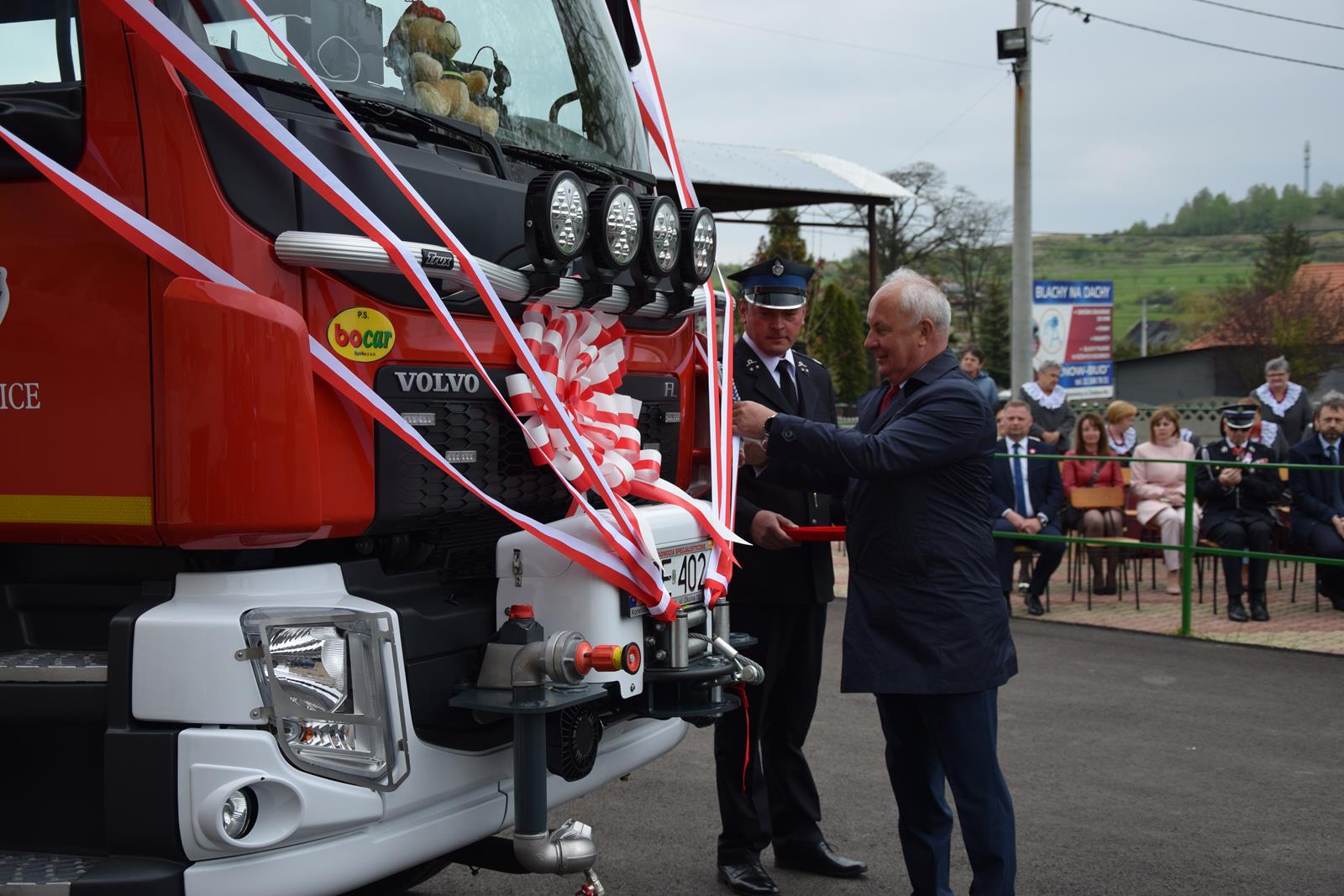 Zdjęcie podczas uroczystości odbywających się przed strażnicą OSP w Toporowicach - przecinanie wstęgi przez Wójta Gminy Mierzęcice Grzegorza Podlejskiego