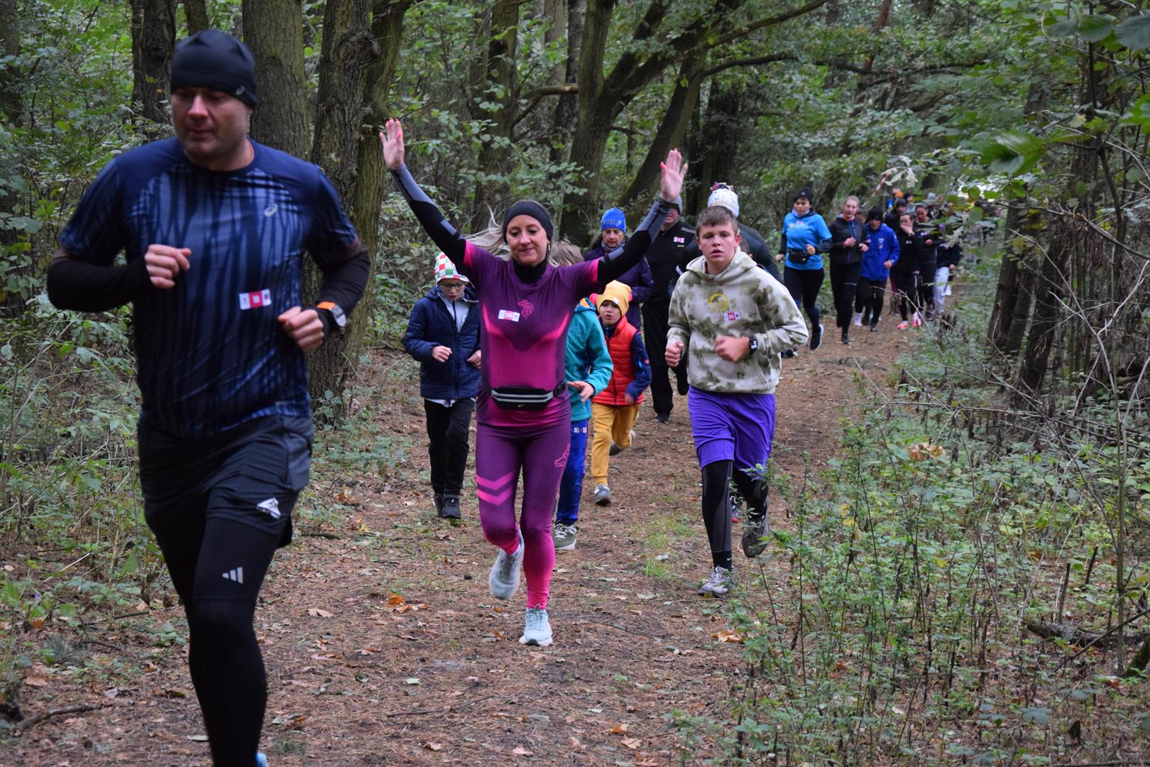 Zdjęcie przedstawia uczestników wydarzenia na trasie biegu