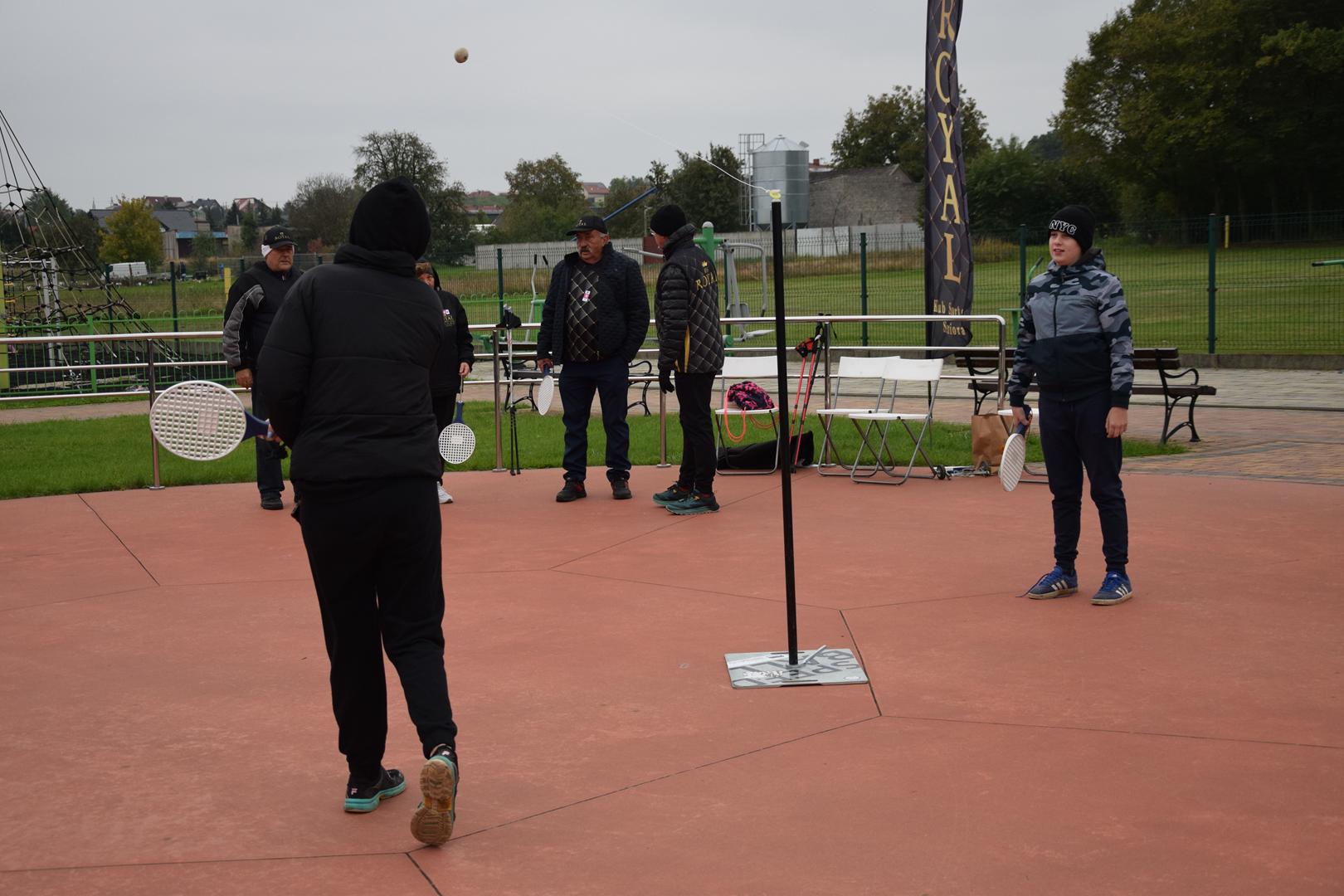 Zdjęcie przedstawia uczestników wydarzenia podczas gry w&nbsp;tenisa