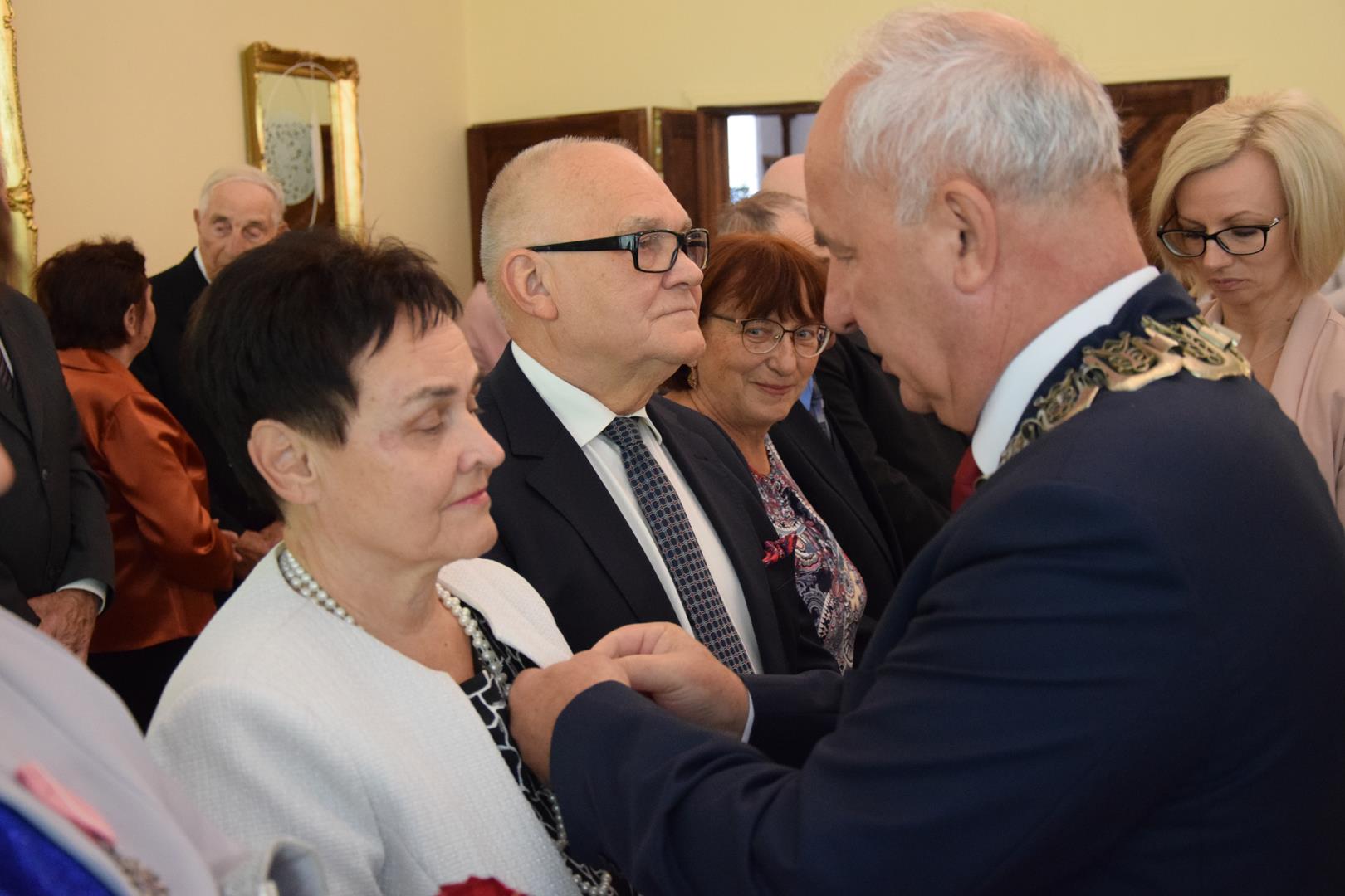 Zdjęcie przedstawia moment rozdania medali i legitymacji